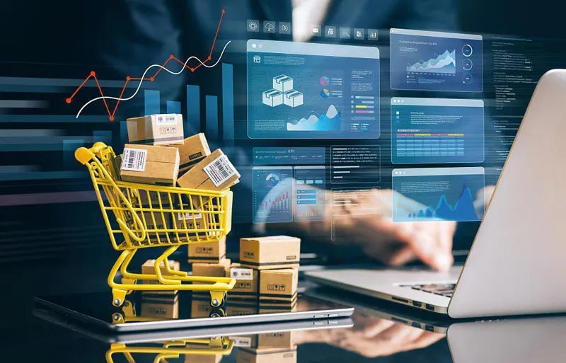 Carrello con pacchi davanti a un portatile: commercio elettronico